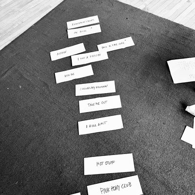 Set-list cards laid out in running order on a rehearsal room floor.