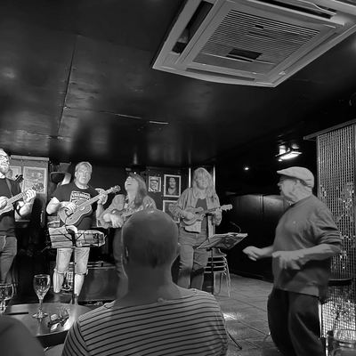 The view from the audience at Fingers Piano Bar, a packed room watching the band.