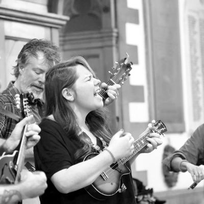 Four players leaning into a chorus at Leith St Andrew's, fiddle on the right.